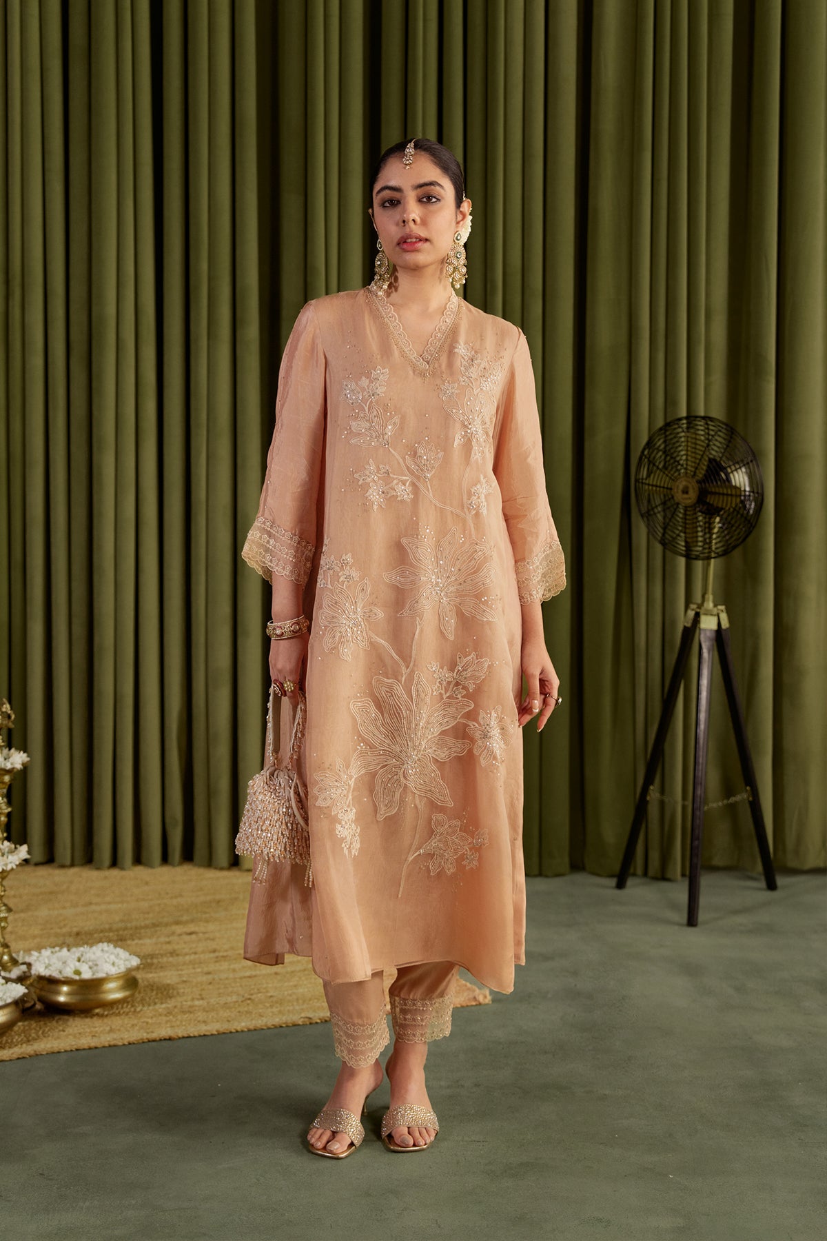 Golden beige kurta set with delicate floral embroidery.