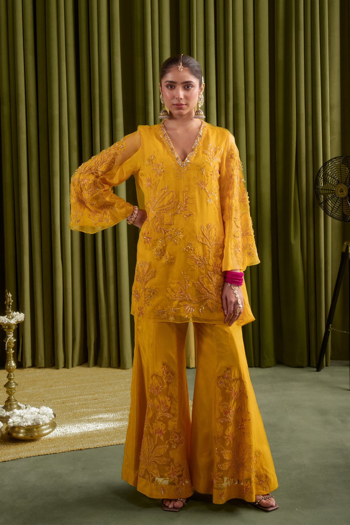 Golden yellow sharara set with embroidered magnolia flower pattern.