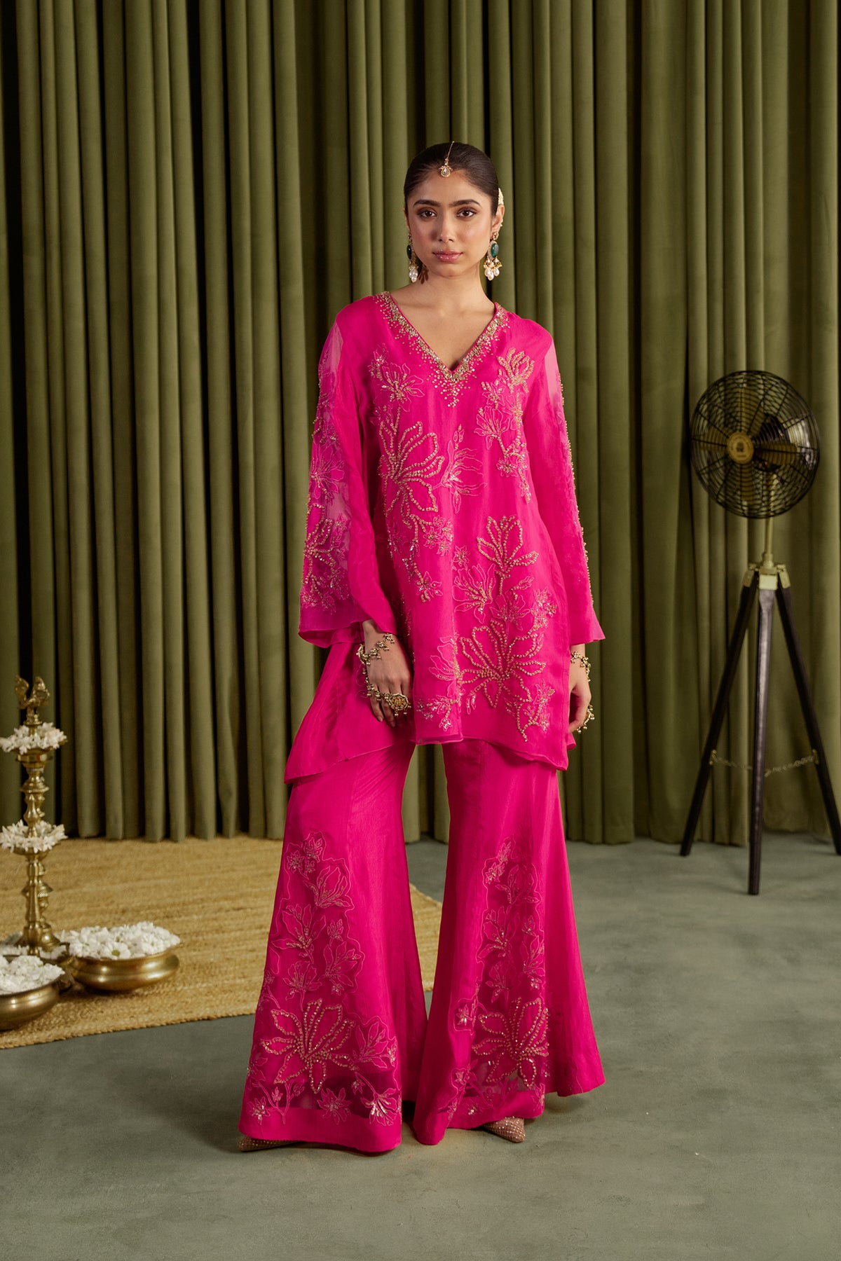 Hot pink sharara set with embroidered magnolia flower pattern.