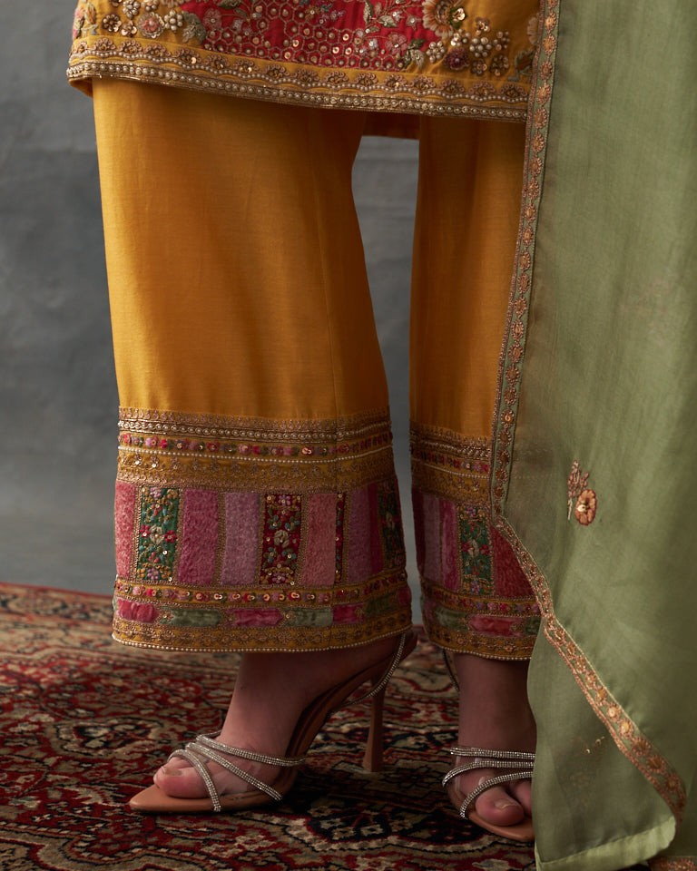 Velvet patchwork Knee length yellow kurta with pants & organza dupatta.