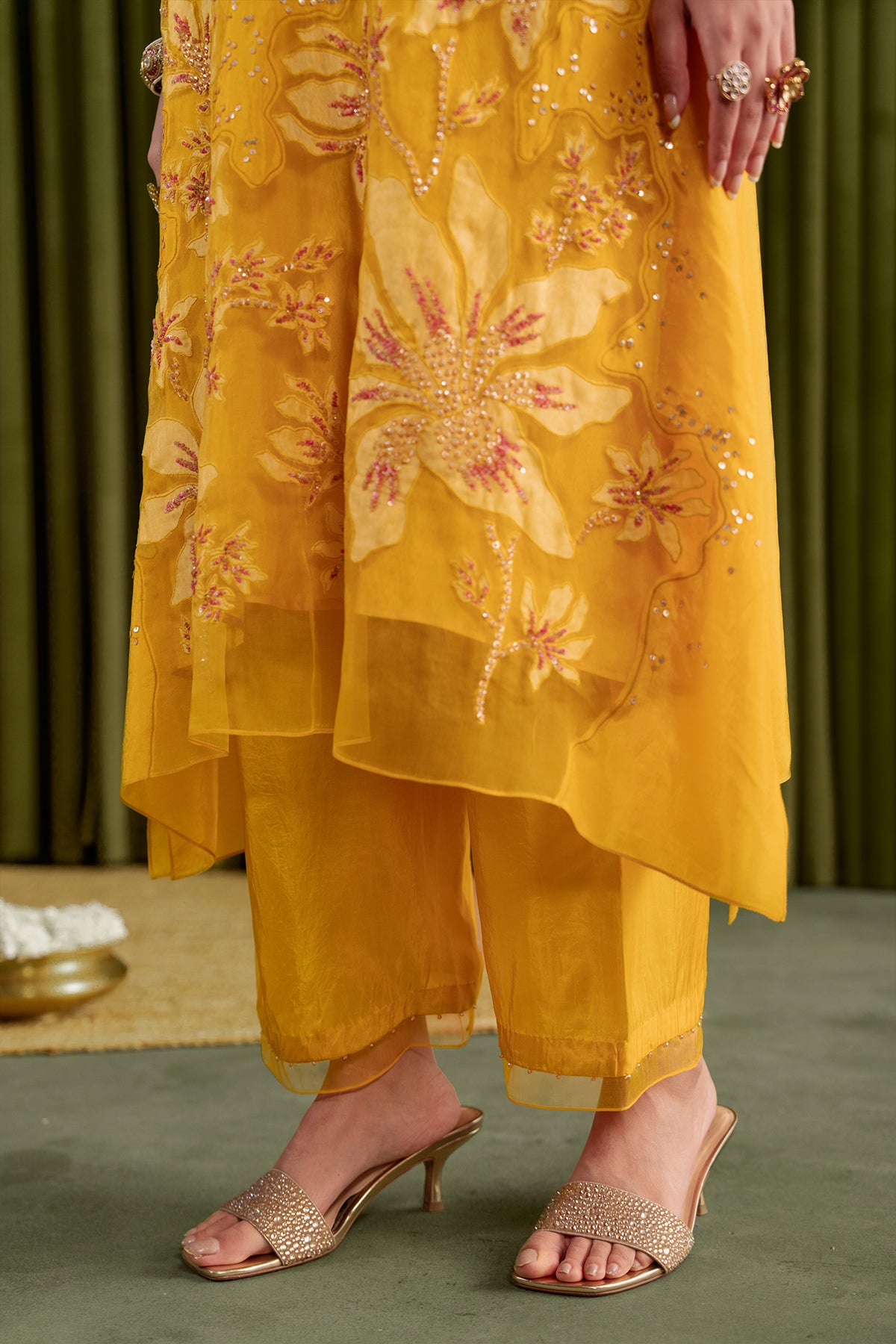 Golden yellow kurta set in viscose silk base with embroidered magnolia flower pattern.