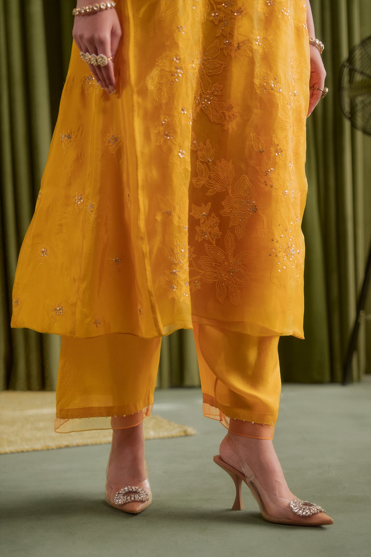 Golden yellow kalidar kurta set with delicate floral embroidery.