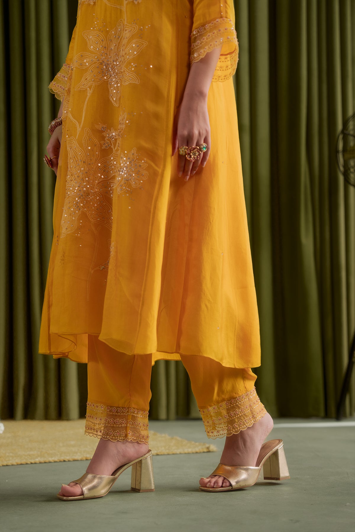 Golden yellow kurta set with delicate floral embroidery.