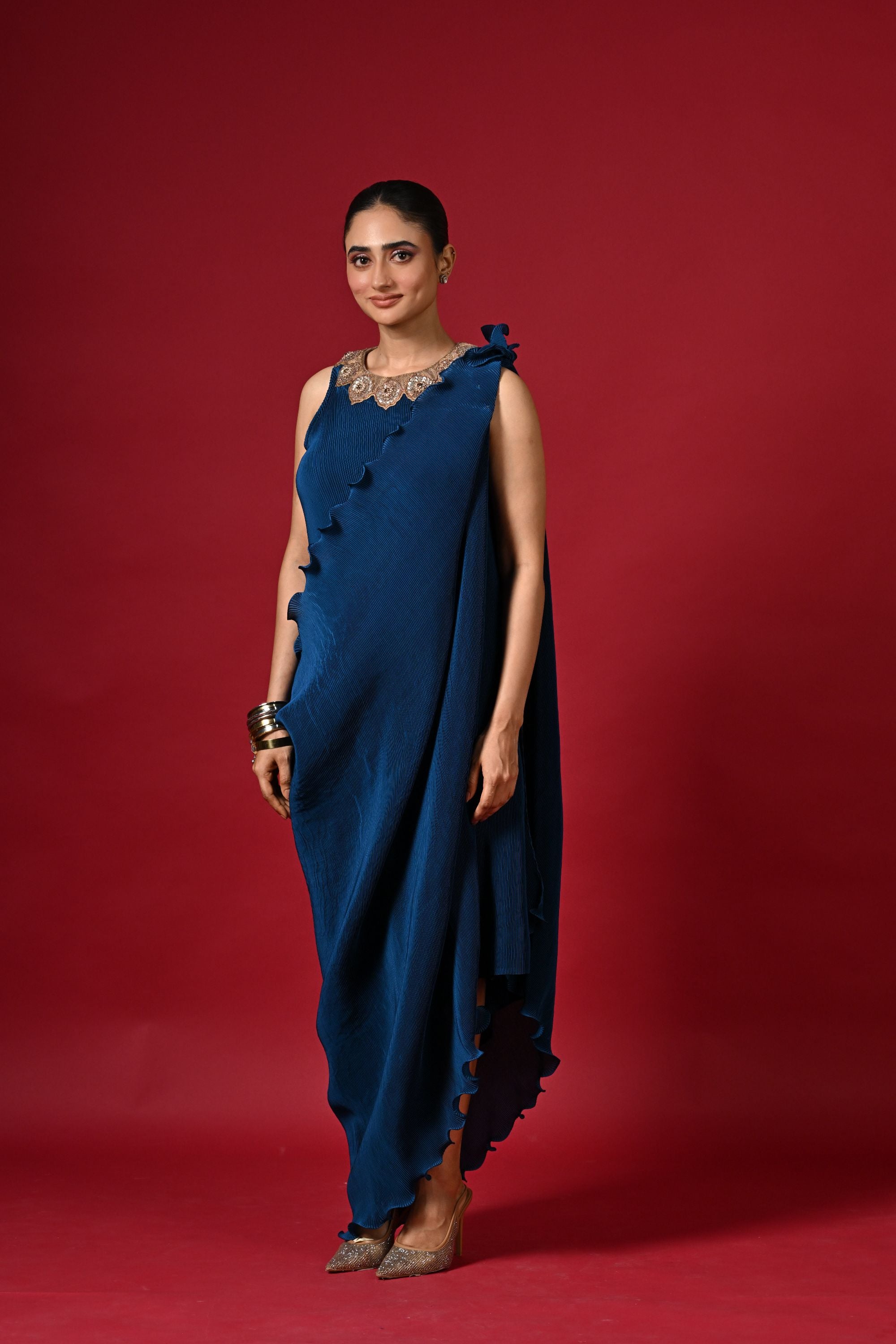 Blue pleated dress with embroidery detail and pleated drape