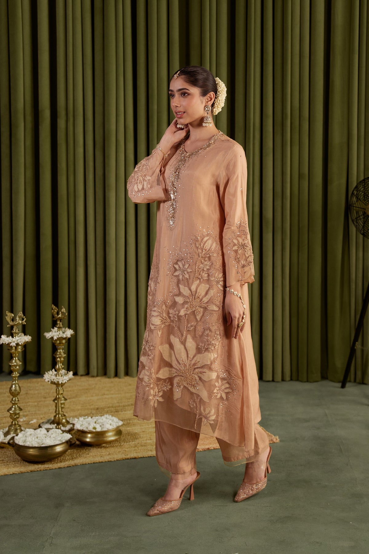 Golden beige kurta set in viscose silk base with embroidered magnolia flower pattern.