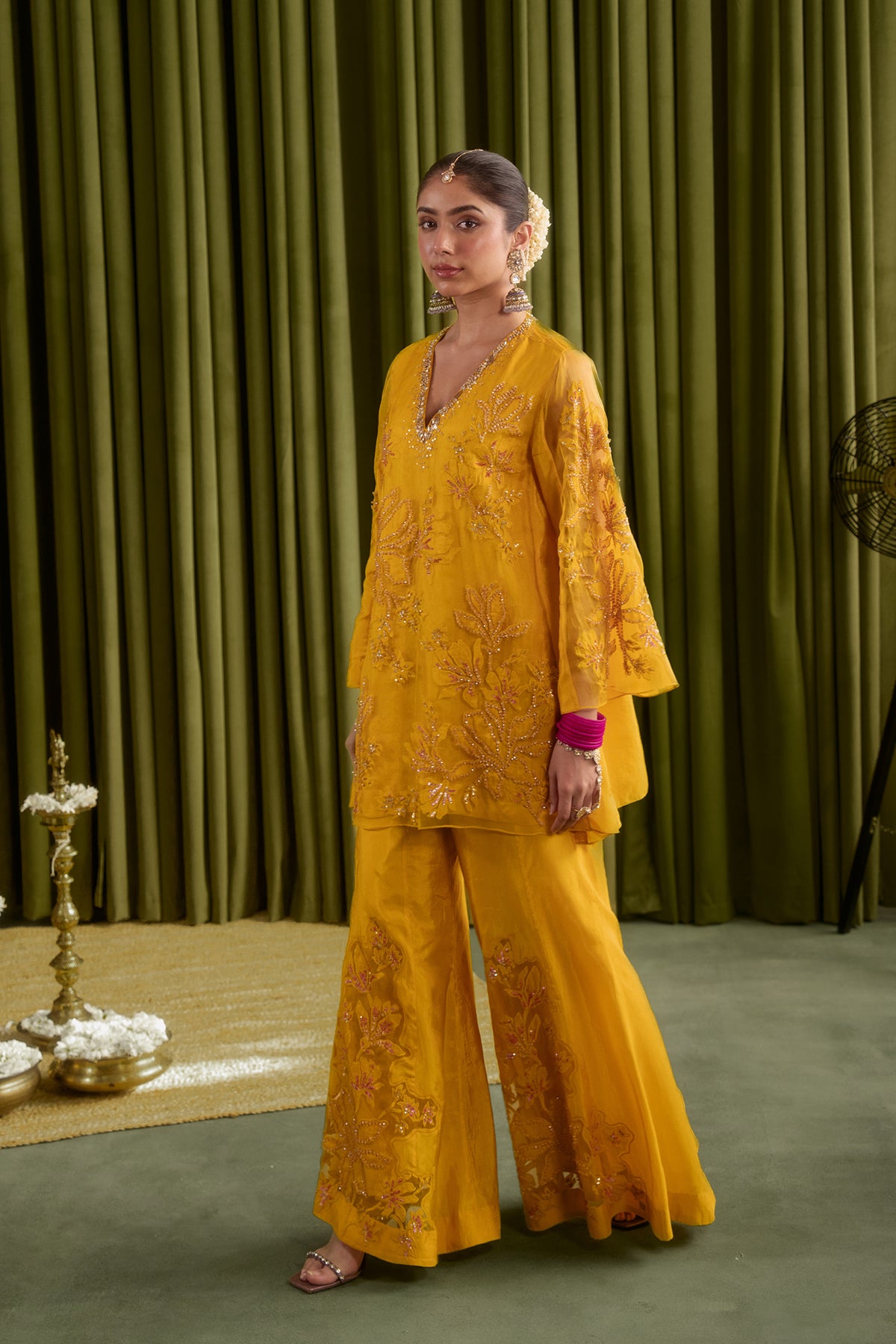 Golden yellow sharara set with embroidered magnolia flower pattern.