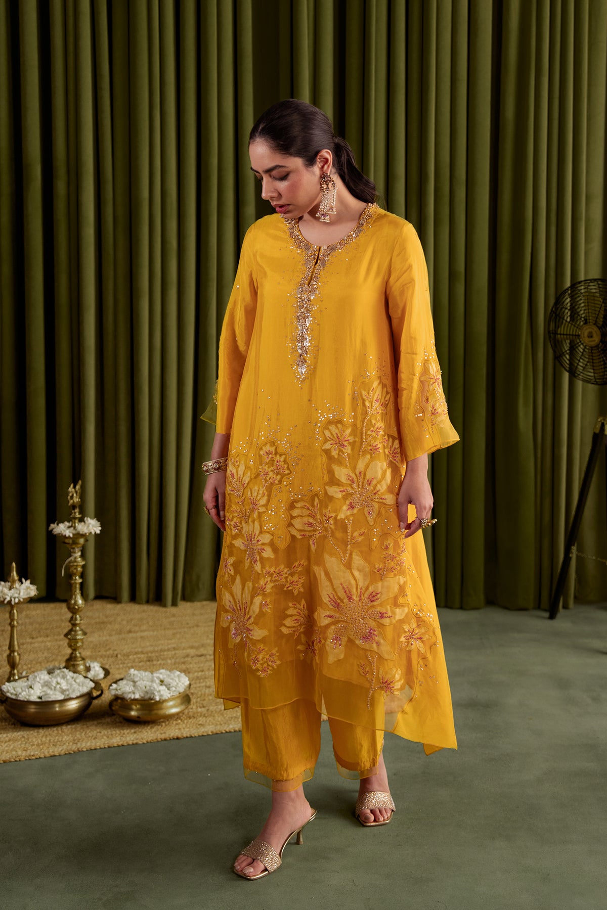Golden yellow kurta set in viscose silk base with embroidered magnolia flower pattern.