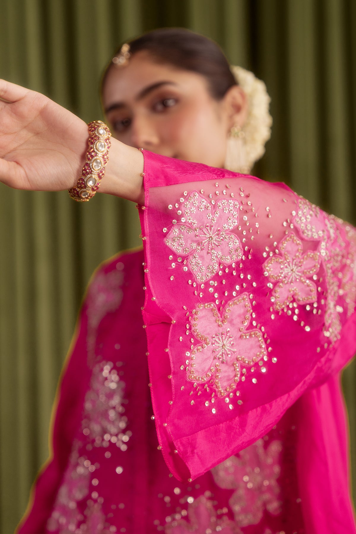 Hot pink co-ord set with embroidered floral pattern.