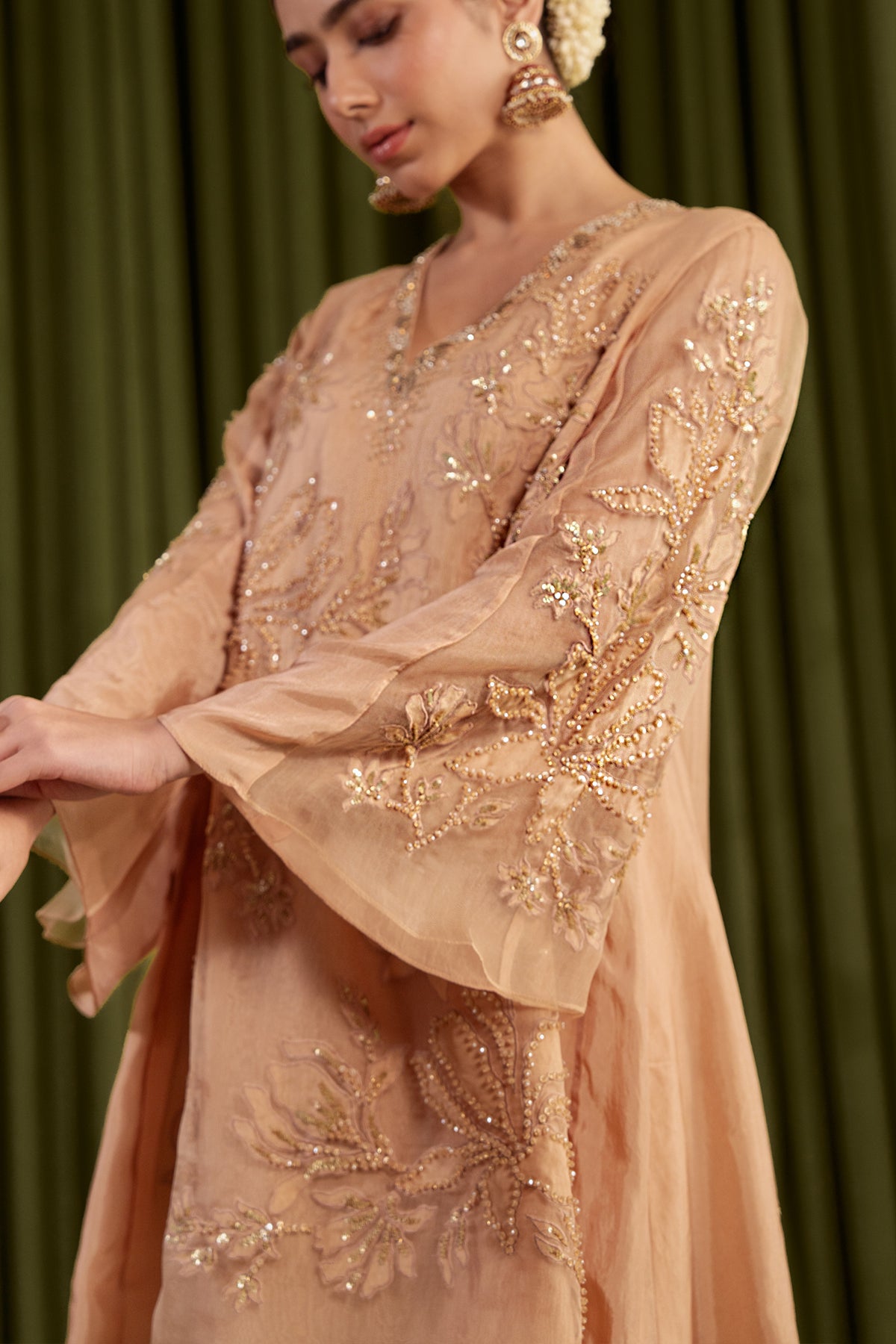 Golden beige sharara set with embroidered magnolia flower pattern.