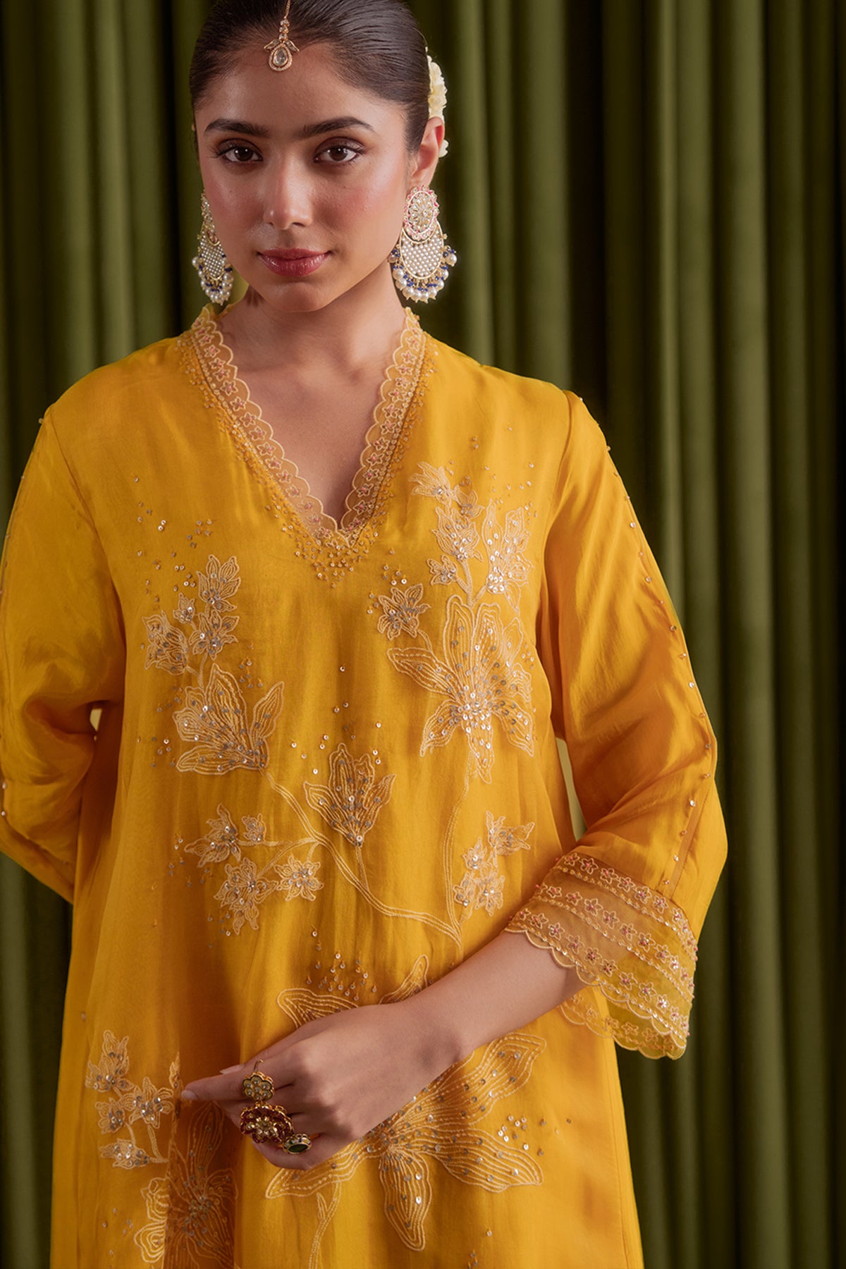 Golden yellow kurta set with delicate floral embroidery.