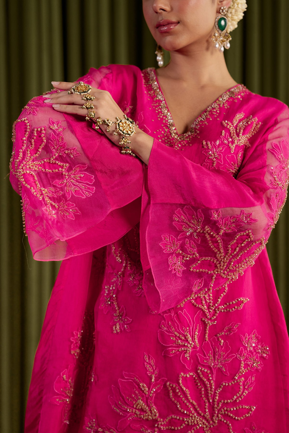 Hot pink sharara set with embroidered magnolia flower pattern.