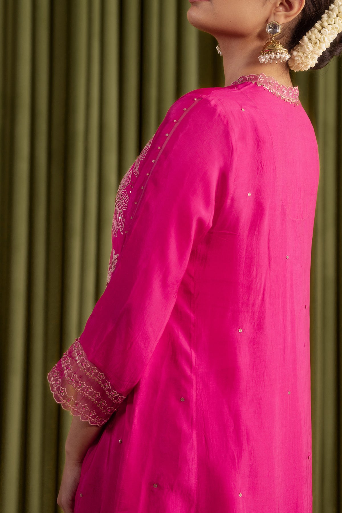 Hot pink kurta set with delicate floral embroidery.