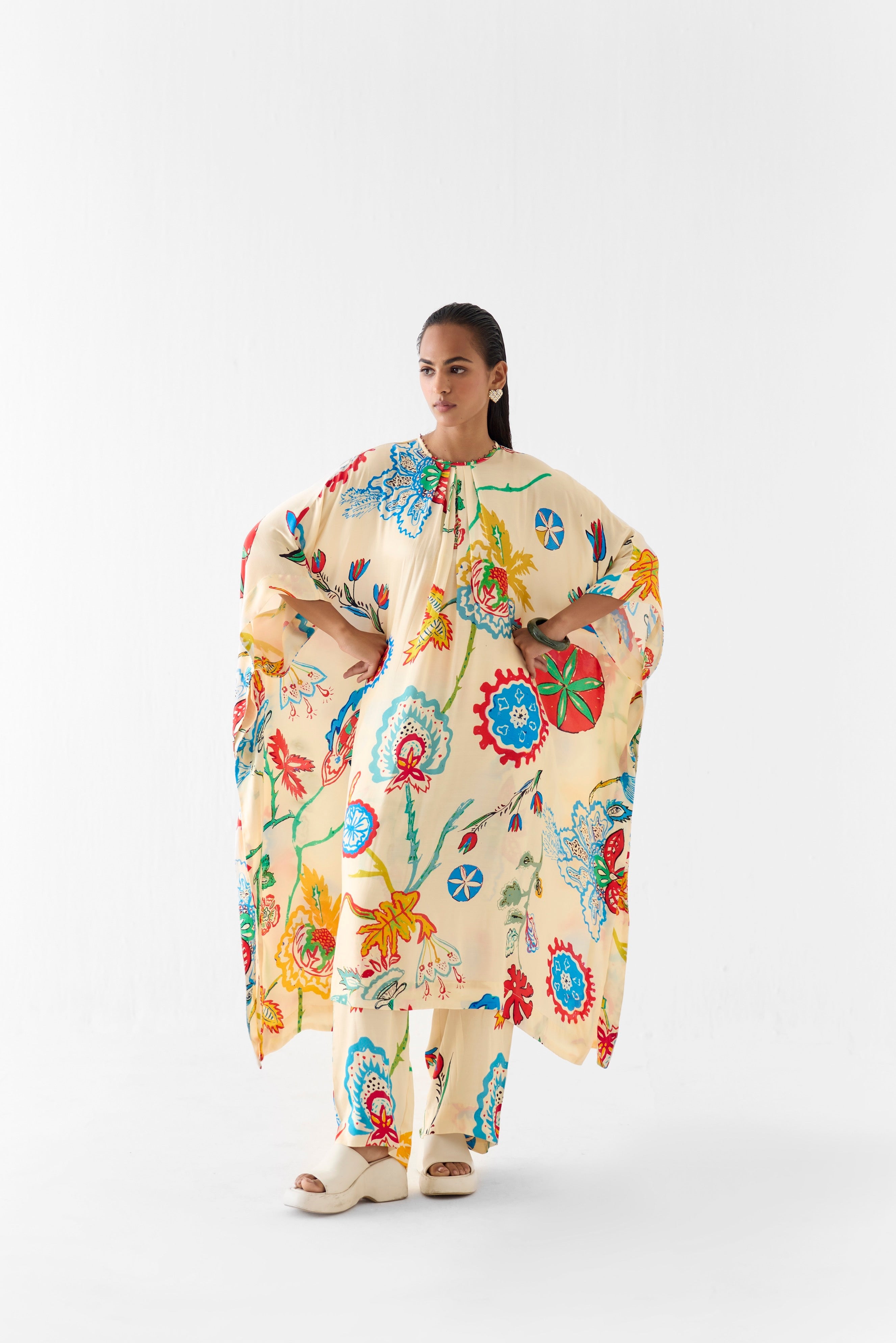 Woman wearing a colorful floral dress on a white background