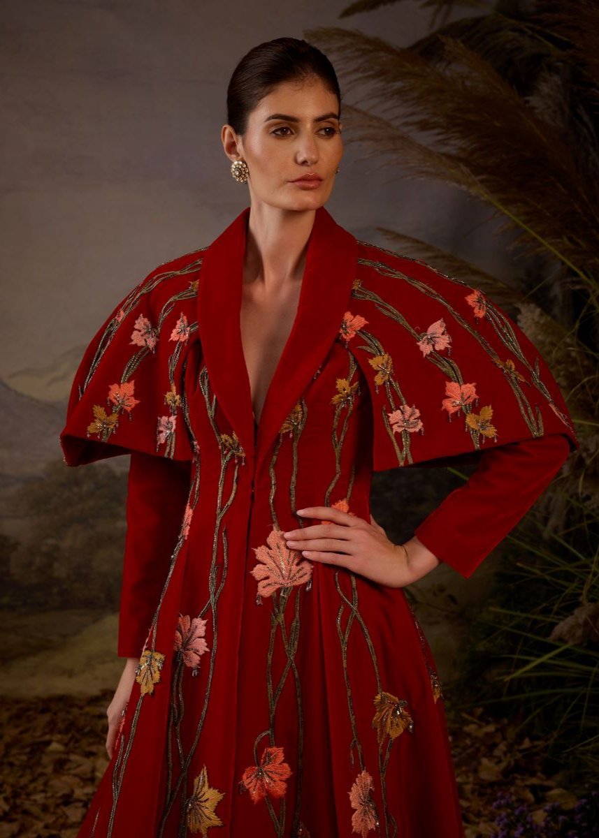 https://cdn.shopify.com/s/files/1/0088/3441/6706/files/a-red-velvet-fabric-floor-length-gown-with-lapel-neck-line-extended-cape-6166820.jpg?v=1752388666