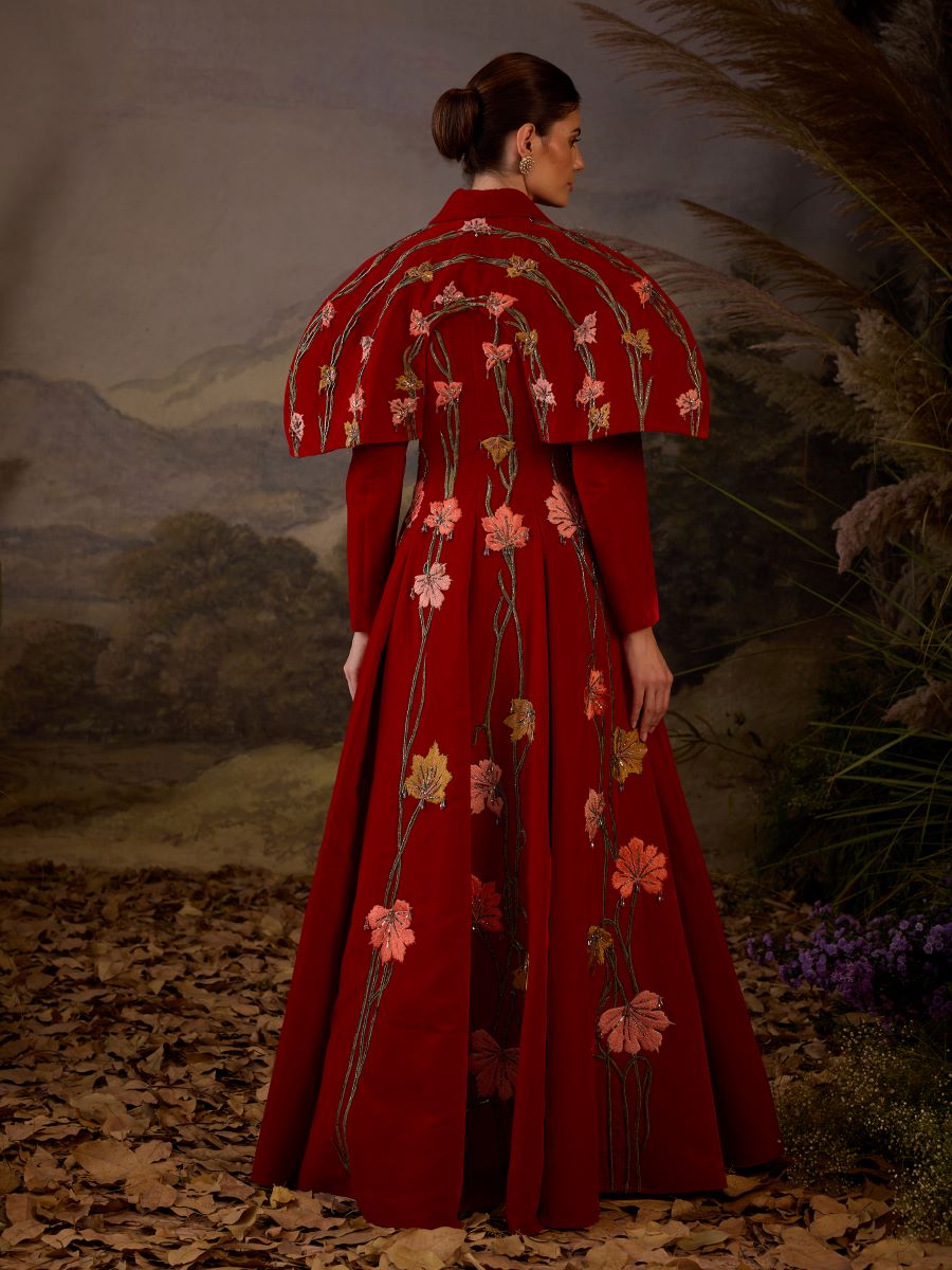 https://cdn.shopify.com/s/files/1/0088/3441/6706/files/a-red-velvet-fabric-floor-length-gown-with-lapel-neck-line-extended-cape-9609419.jpg?v=1752388666