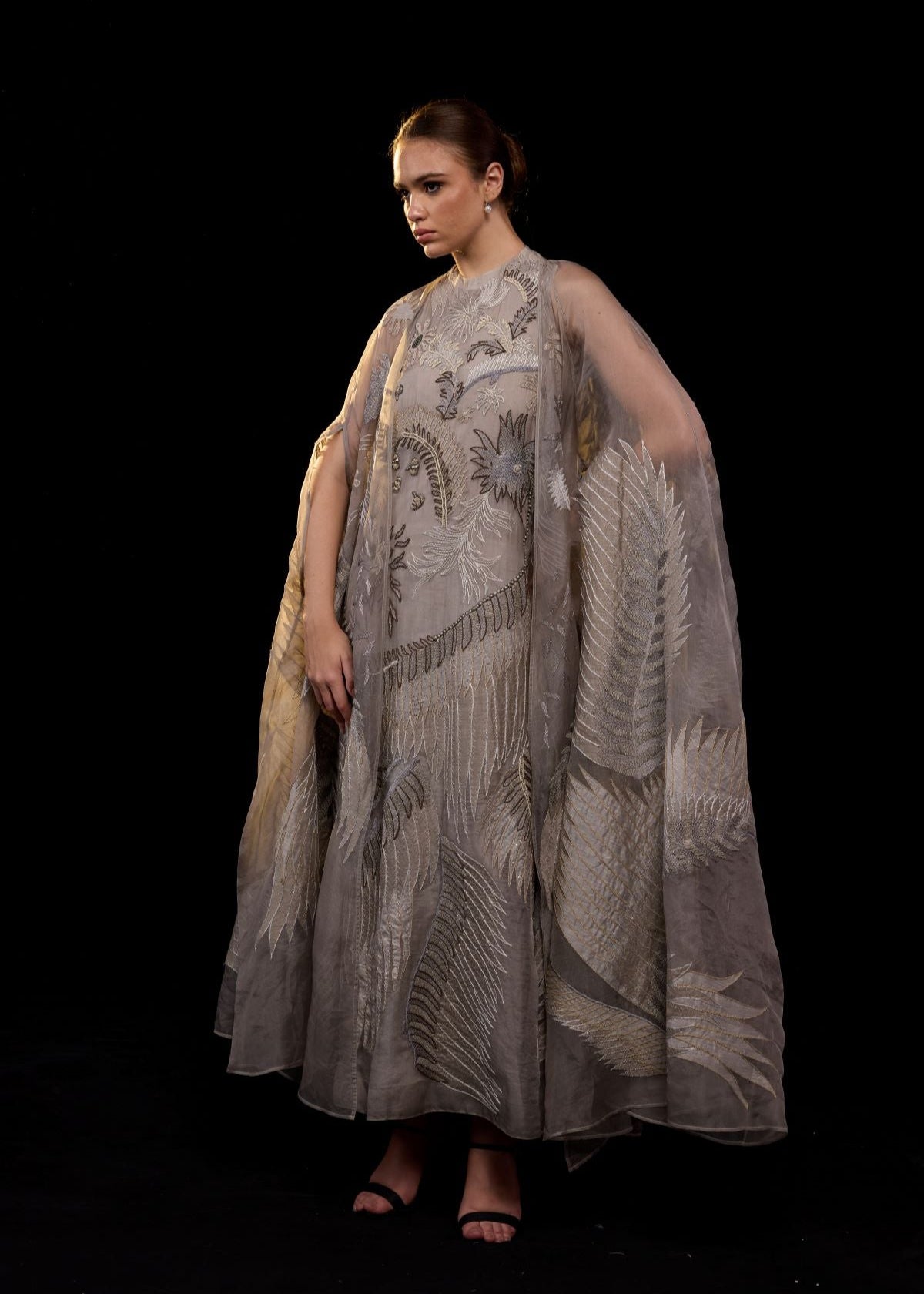 https://cdn.shopify.com/s/files/1/0088/3441/6706/files/ethereal-embroidered-gown-featuring-a-flowing-silhouette-and-a-sheer-cape-overlay-3975276.jpg?v=1753781128