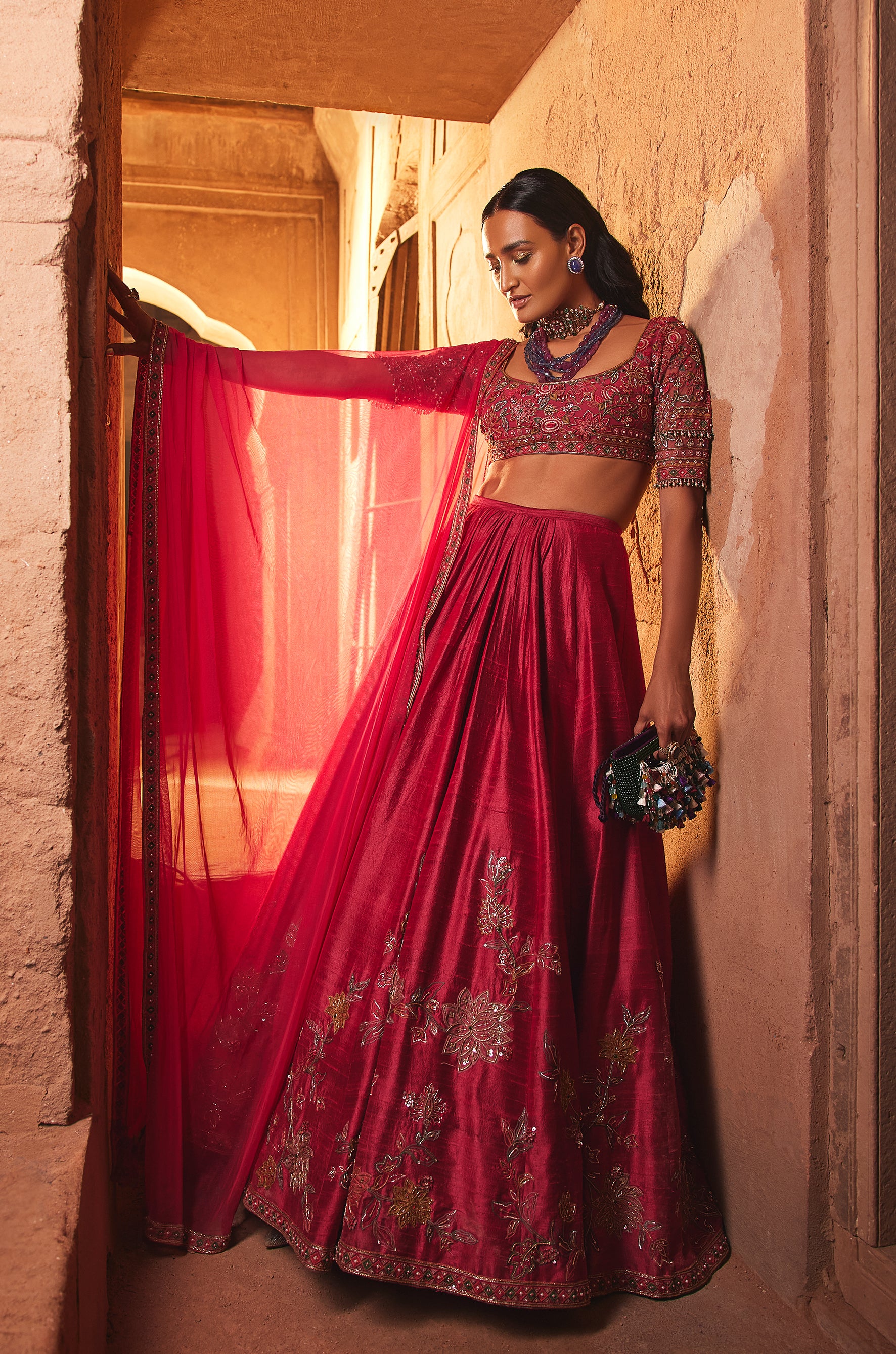 Fuchsia net embroidered blouse and raw silk embroidered lehenga