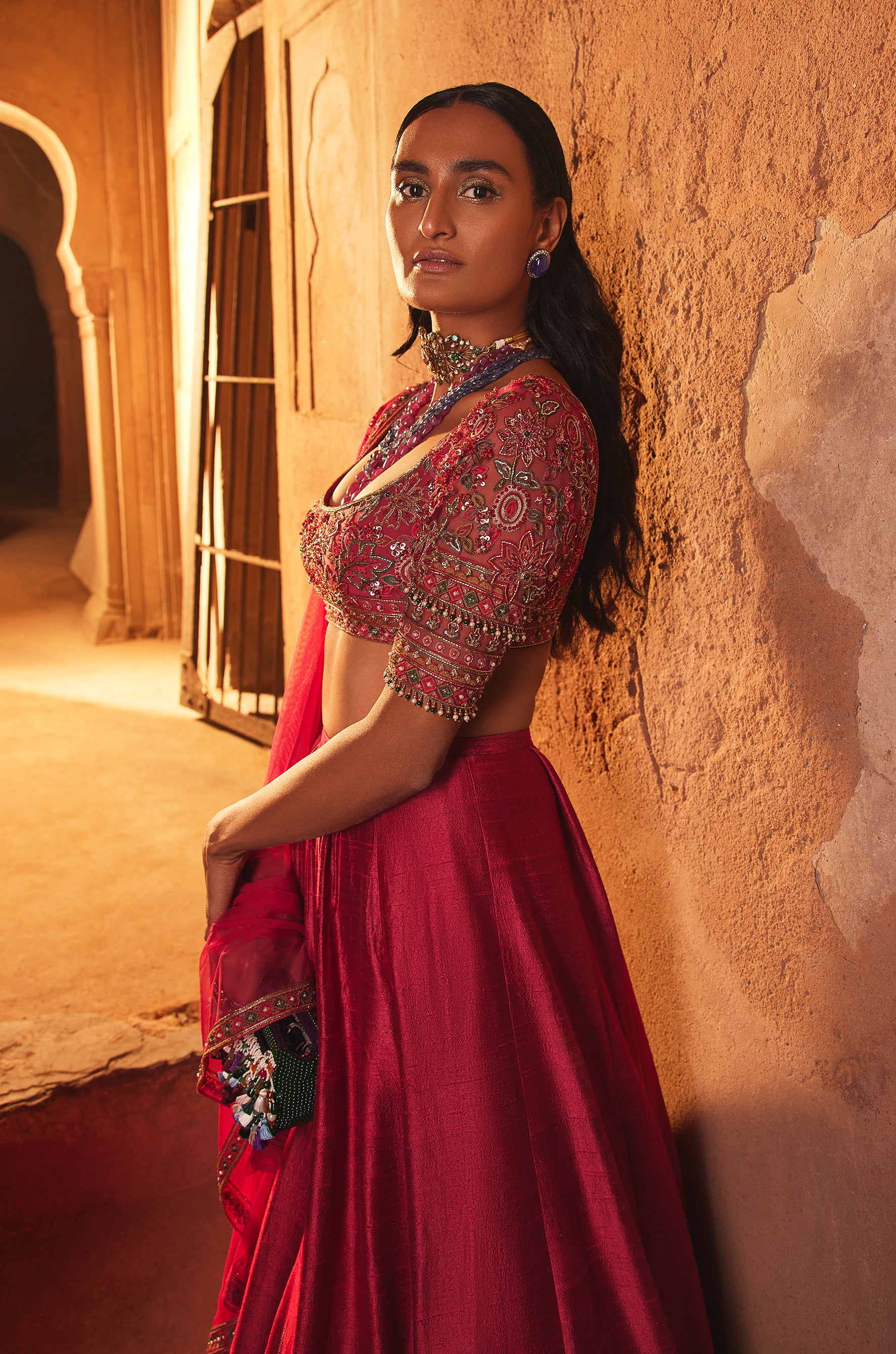 Fuchsia net embroidered blouse and raw silk embroidered lehenga